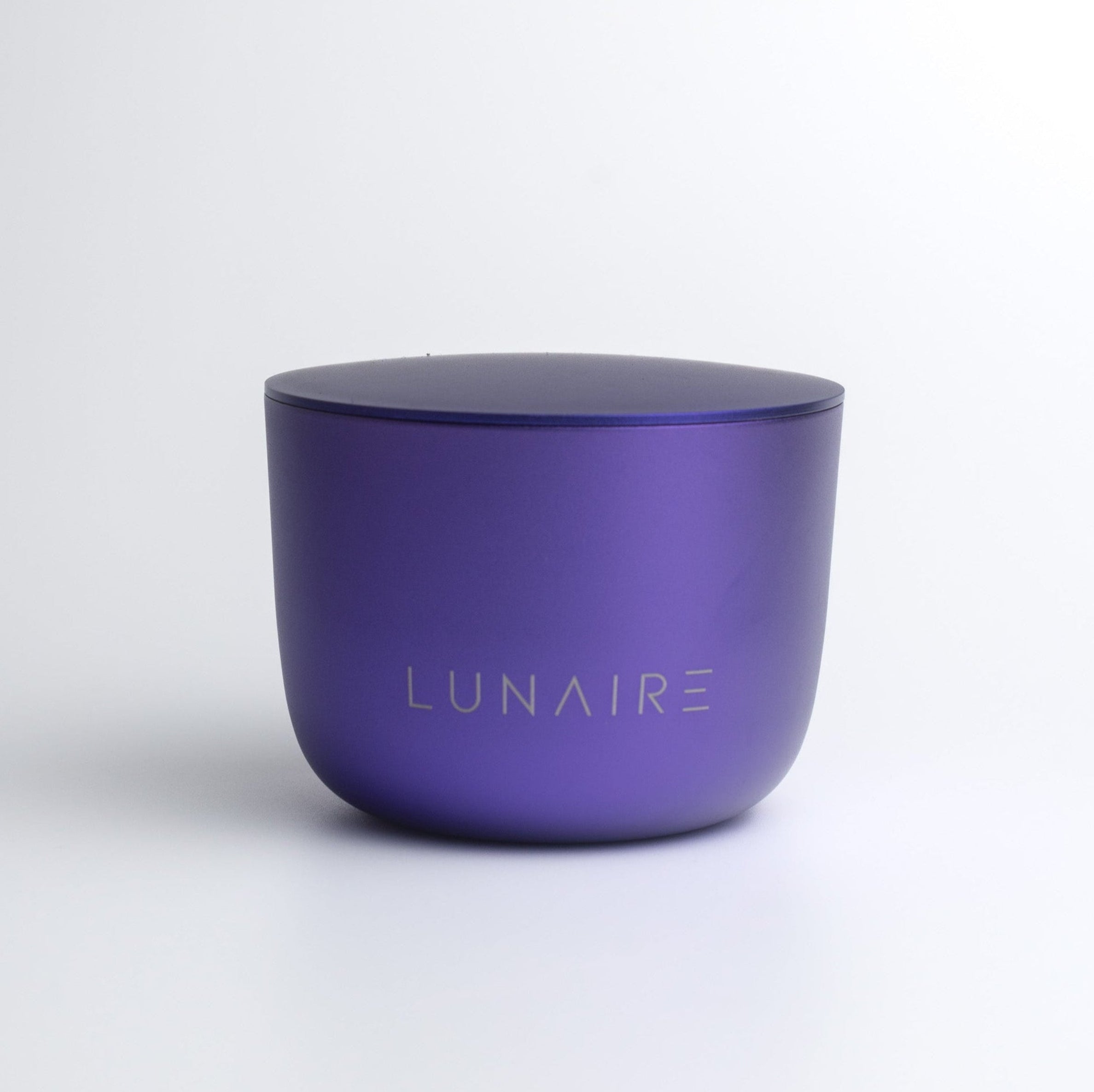 Purple candle with 'LUNAIRE' branding on a white background