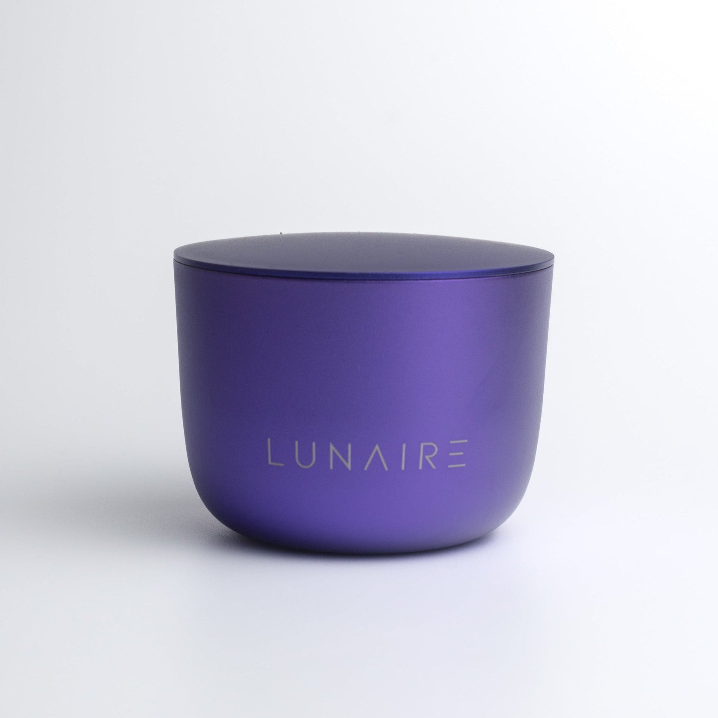 Purple candle with 'LUNAIRE' branding on a white background