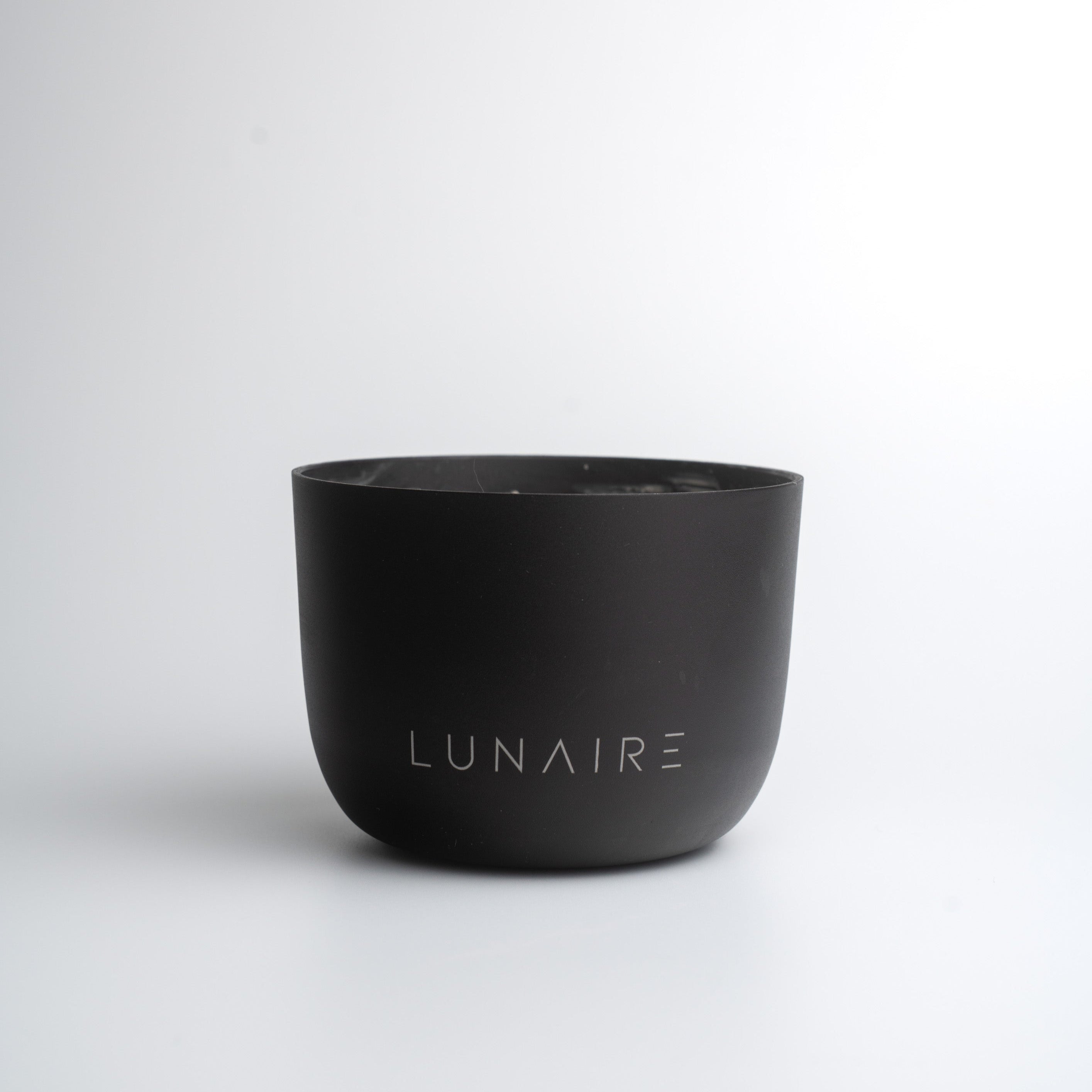 Black aluminium candle jar with 'LUNAIRE' branding on a white background