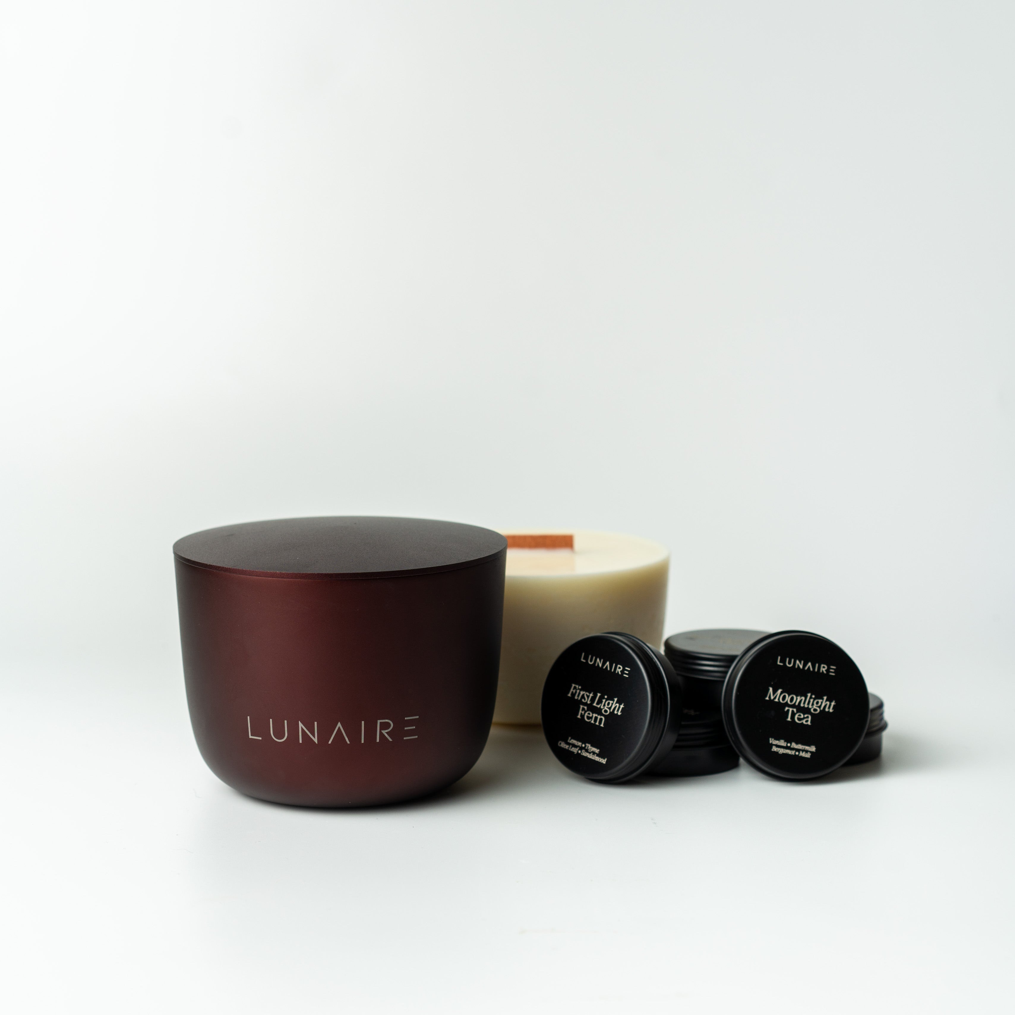 LUNAIRE aluminium refillable candles and tealights on a white background