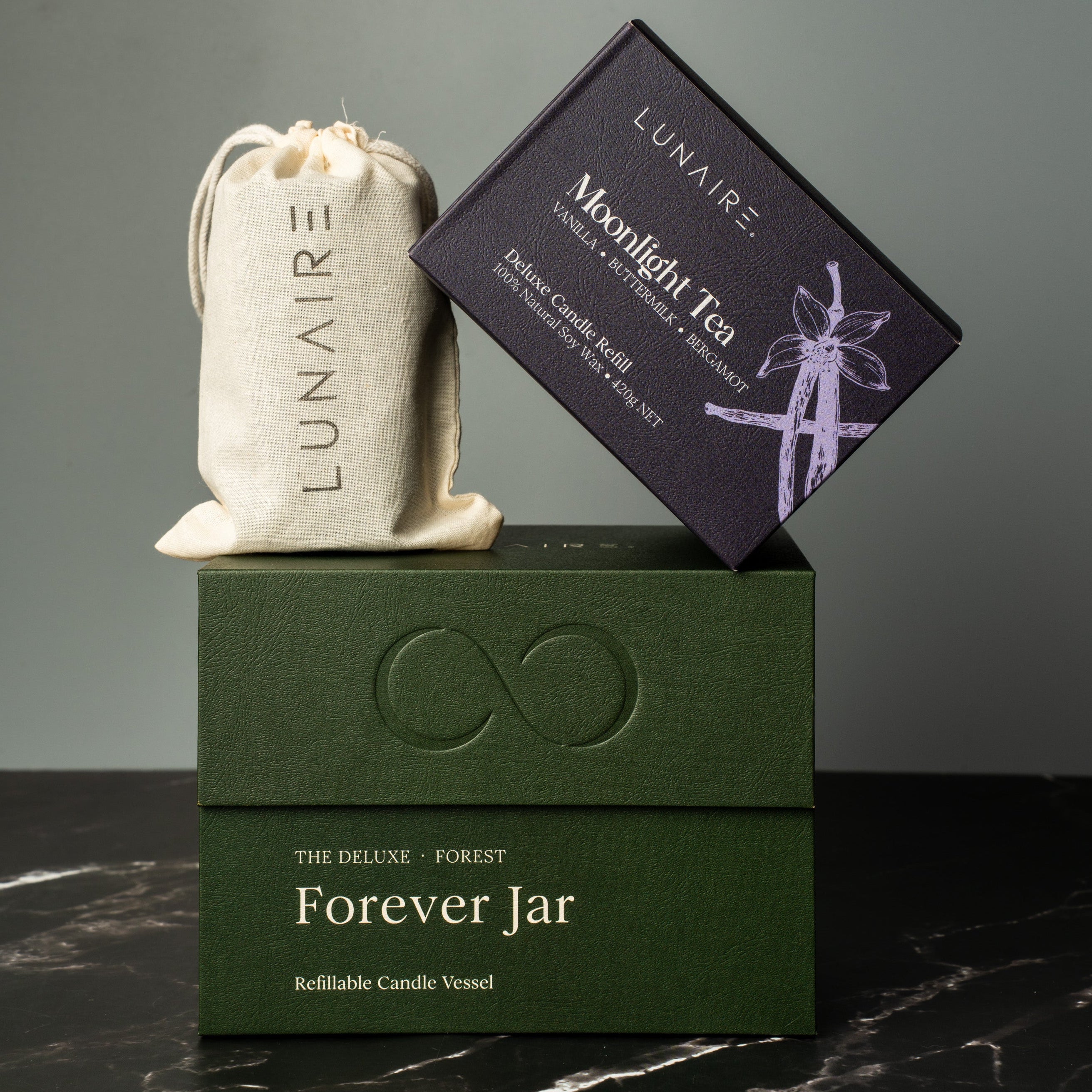 Lunaire product set including a green box, white bag, and black card on a dark surface with gray background