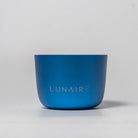 A blue aluminum candle jar with the brand name 'LUNAIRE' engraved on the front.