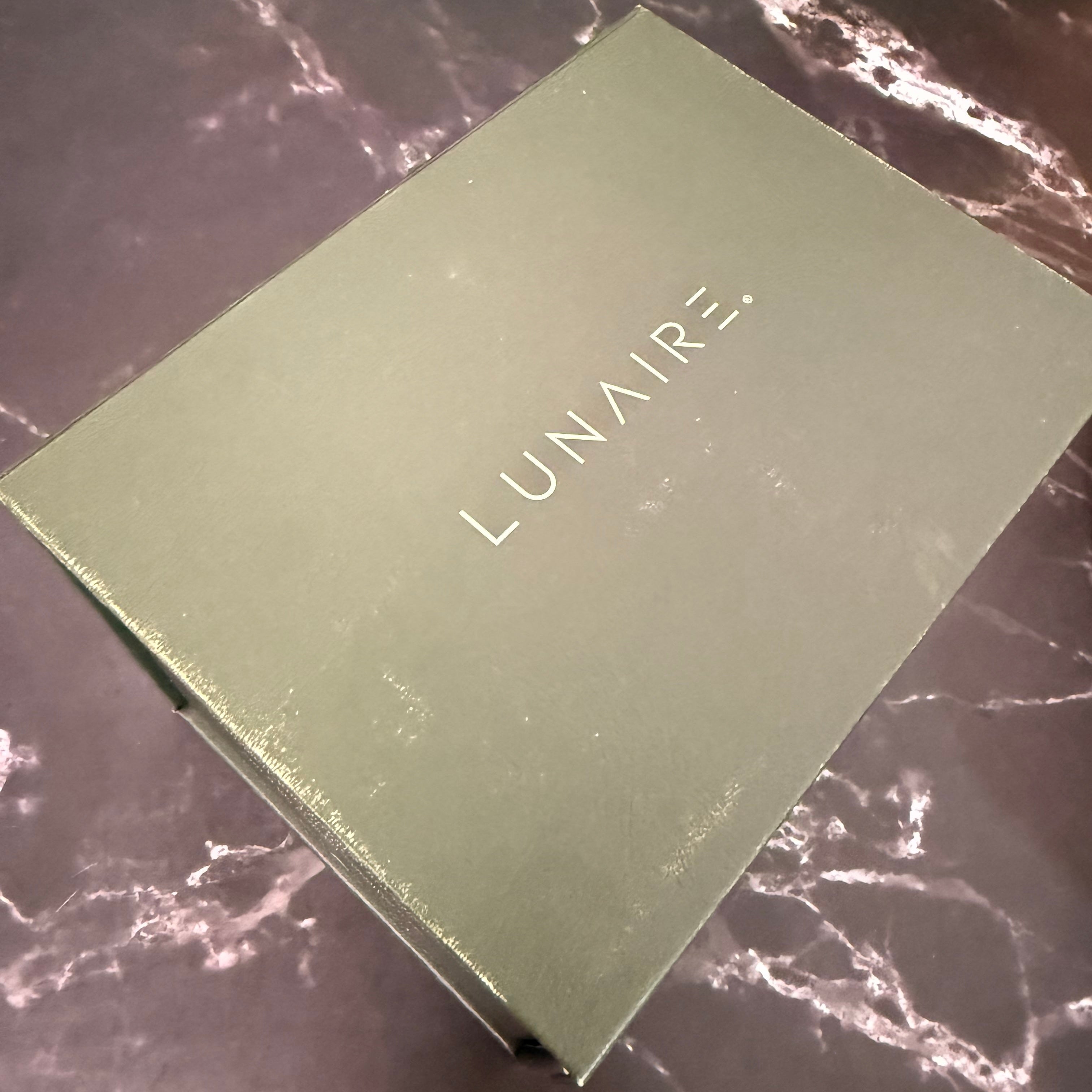 Green box with 'LUNAIRE' branding on a marble surface
