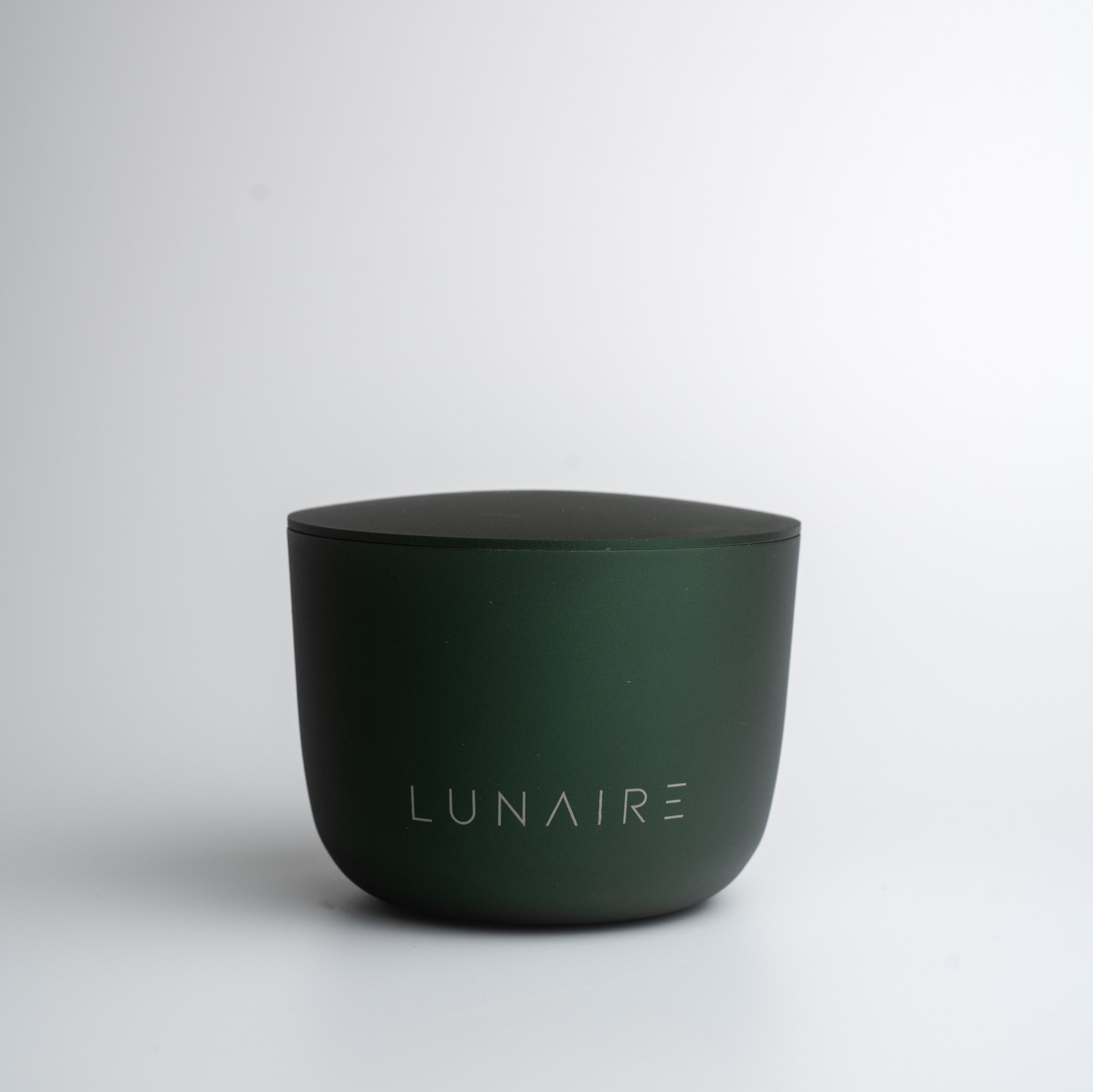 Dark green aluminium forever candle with 'LUNAIRE' branding on a white background