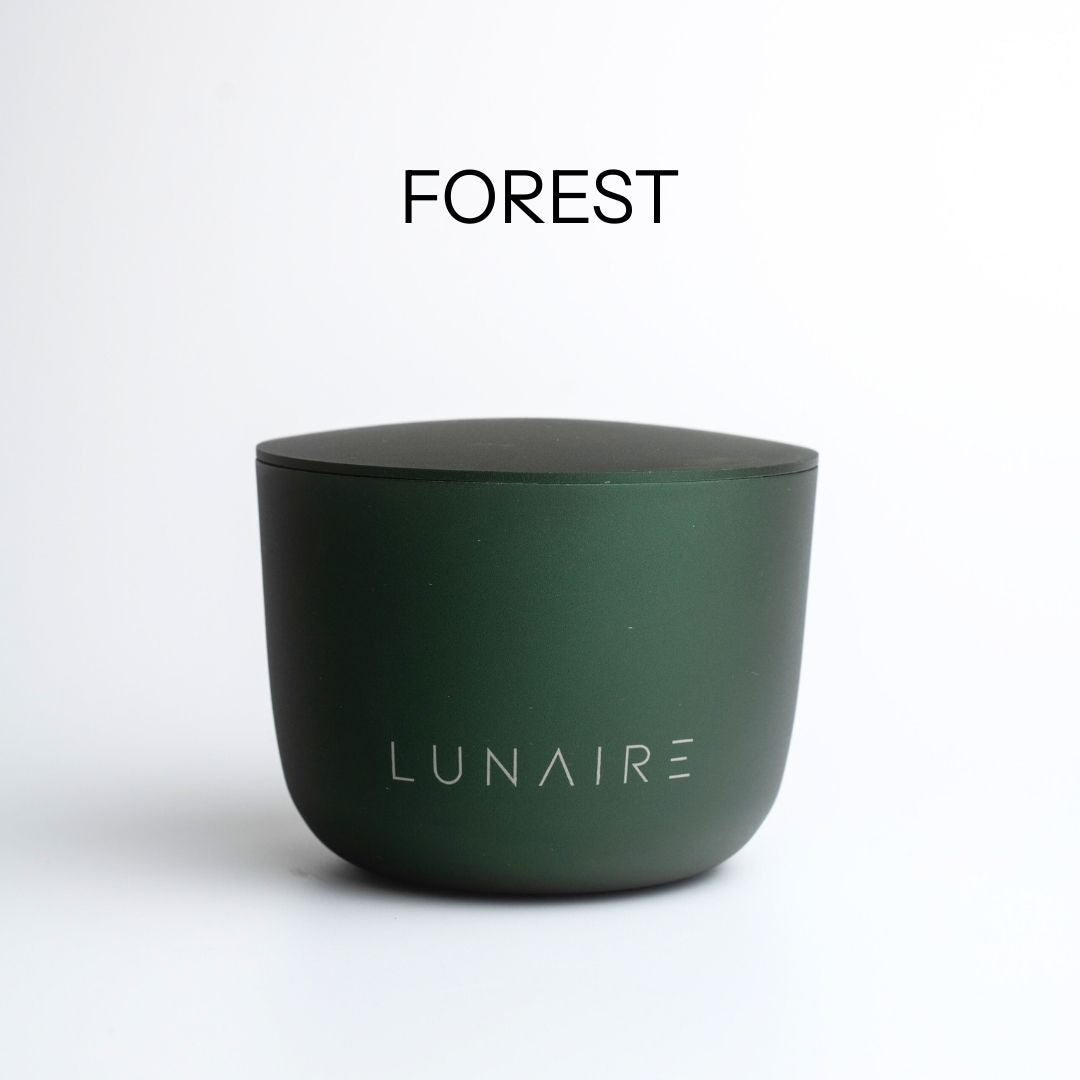 Dark green aluminium candle with 'LUNAIRE' branding on a white background