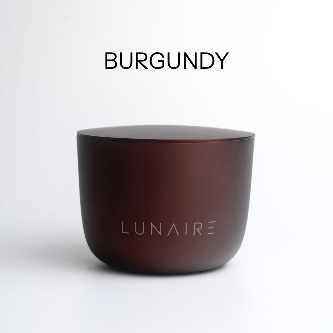 Burgundy aluminium candle jar with 'LUNAIRE' branding on a white background