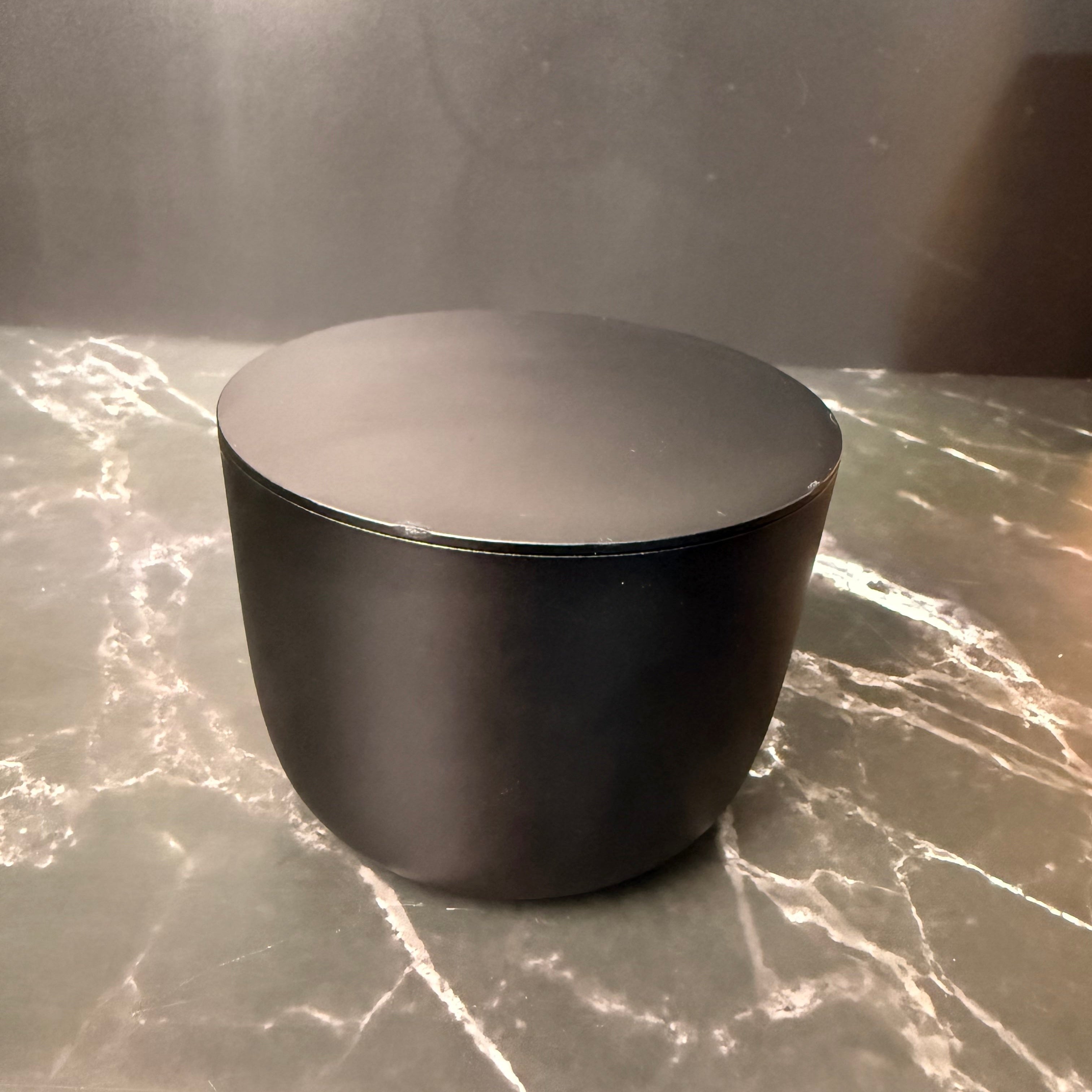 Black Candle on marble surface