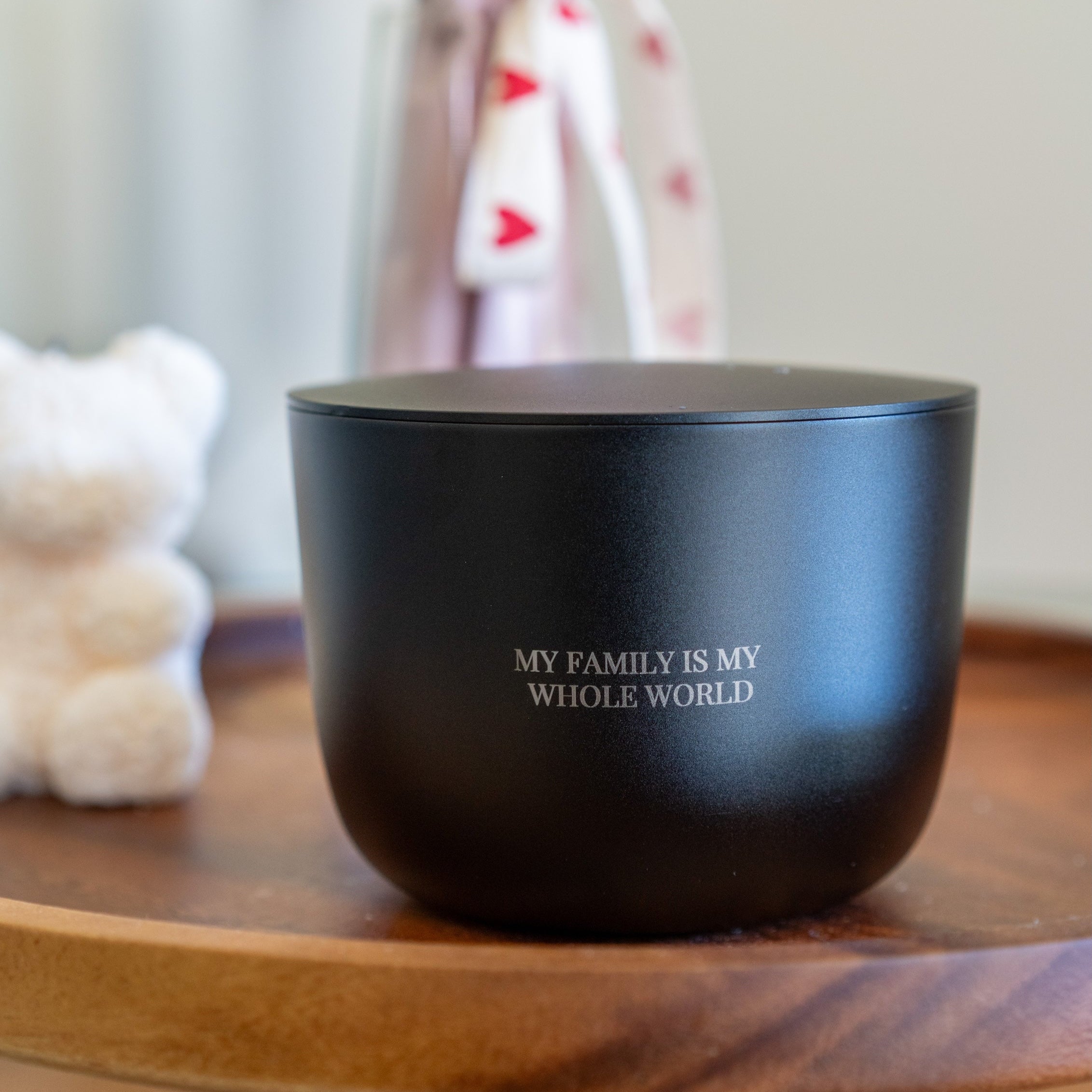 Black luxury aluminium candle gift with 'My family is my whole world' text on a wooden surface