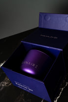 Lunaire Forever Candle  in a purple box with  branding on a dark background. refillable aluminium Candles.