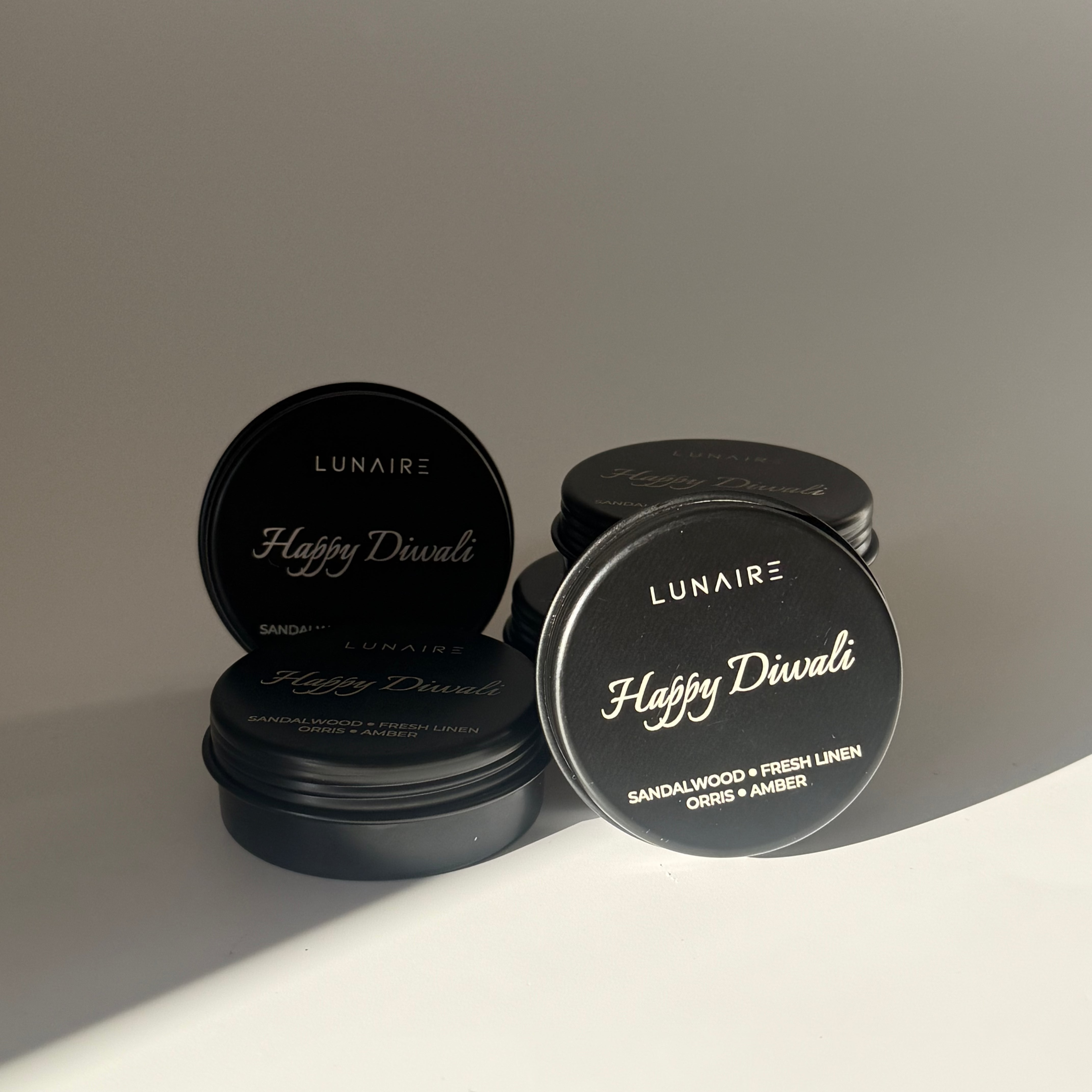 Black soy candles with 'Lunaire' branding on a gradient background