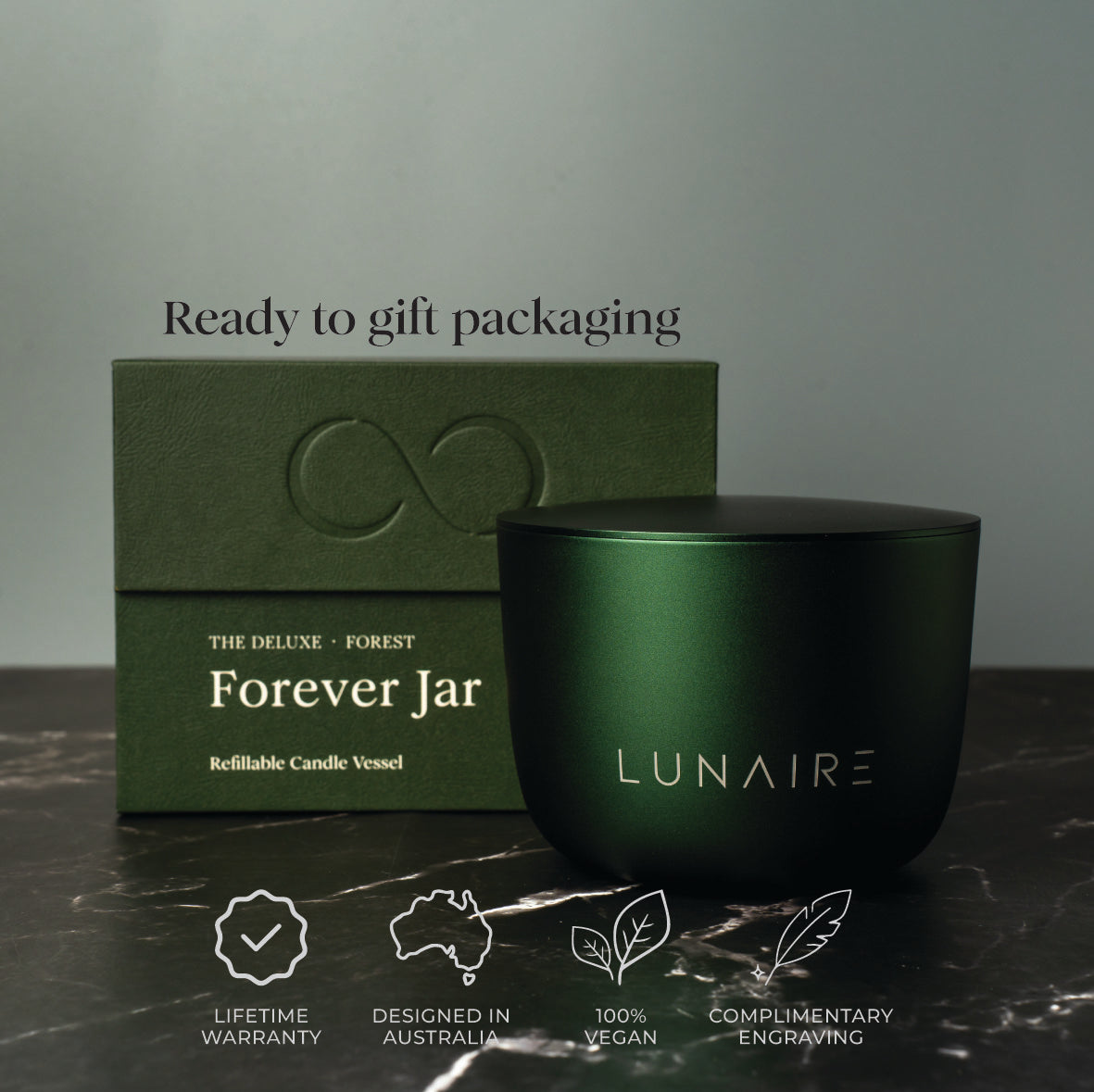 Green candle vessel and packaging with 'LUNAIRE' branding on a dark surface.