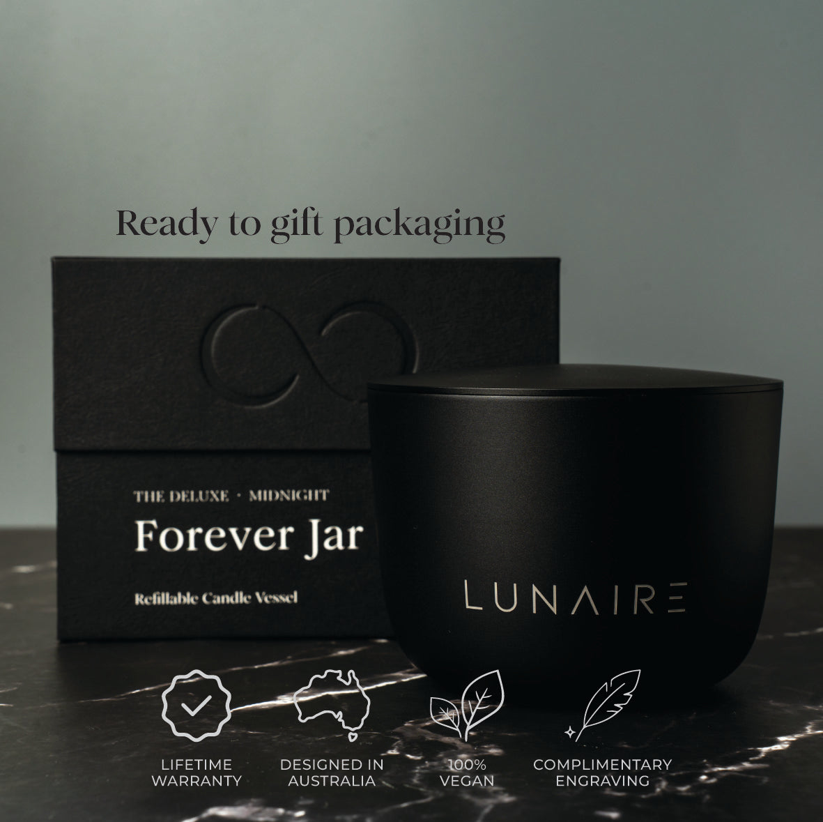 Black candle jar and box with 'LUNAIRE' branding on a dark surface.