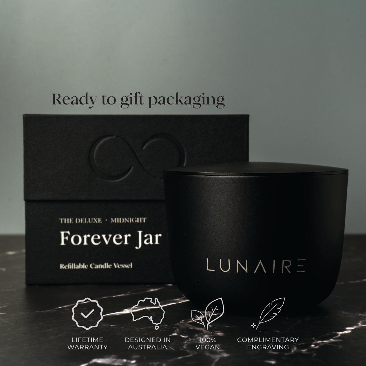 Black candle jar and box with 'LUNAIRE' branding on a dark surface.