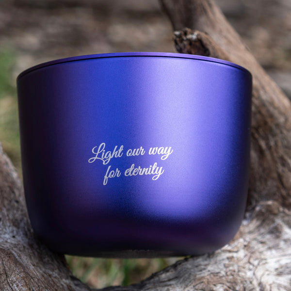 Purple Amethyst  candle with 'Light our way for eternity' personalisation  on a wooden surface