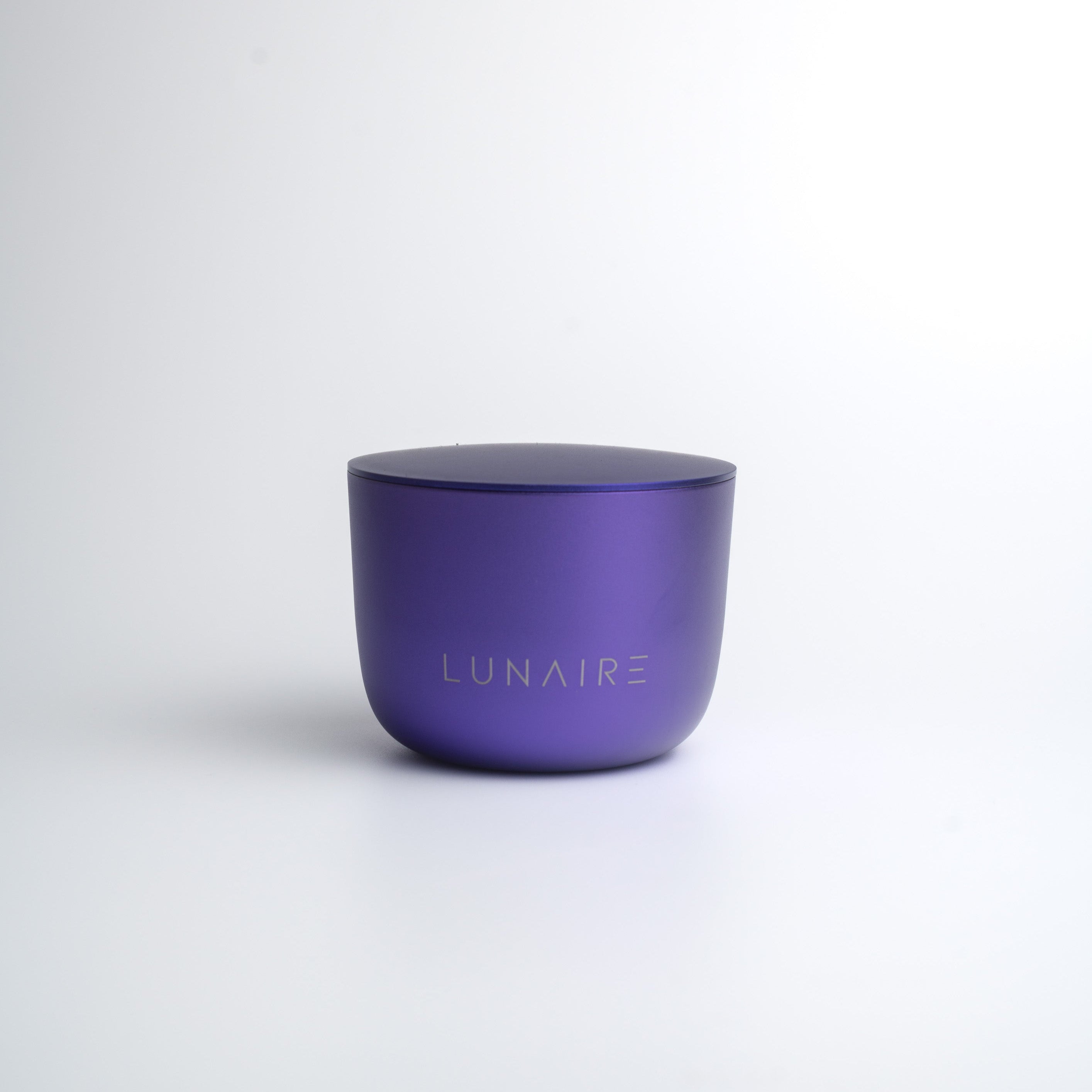 Purple aluminium candle jar with 'LUNAIRE' branding on a white background
