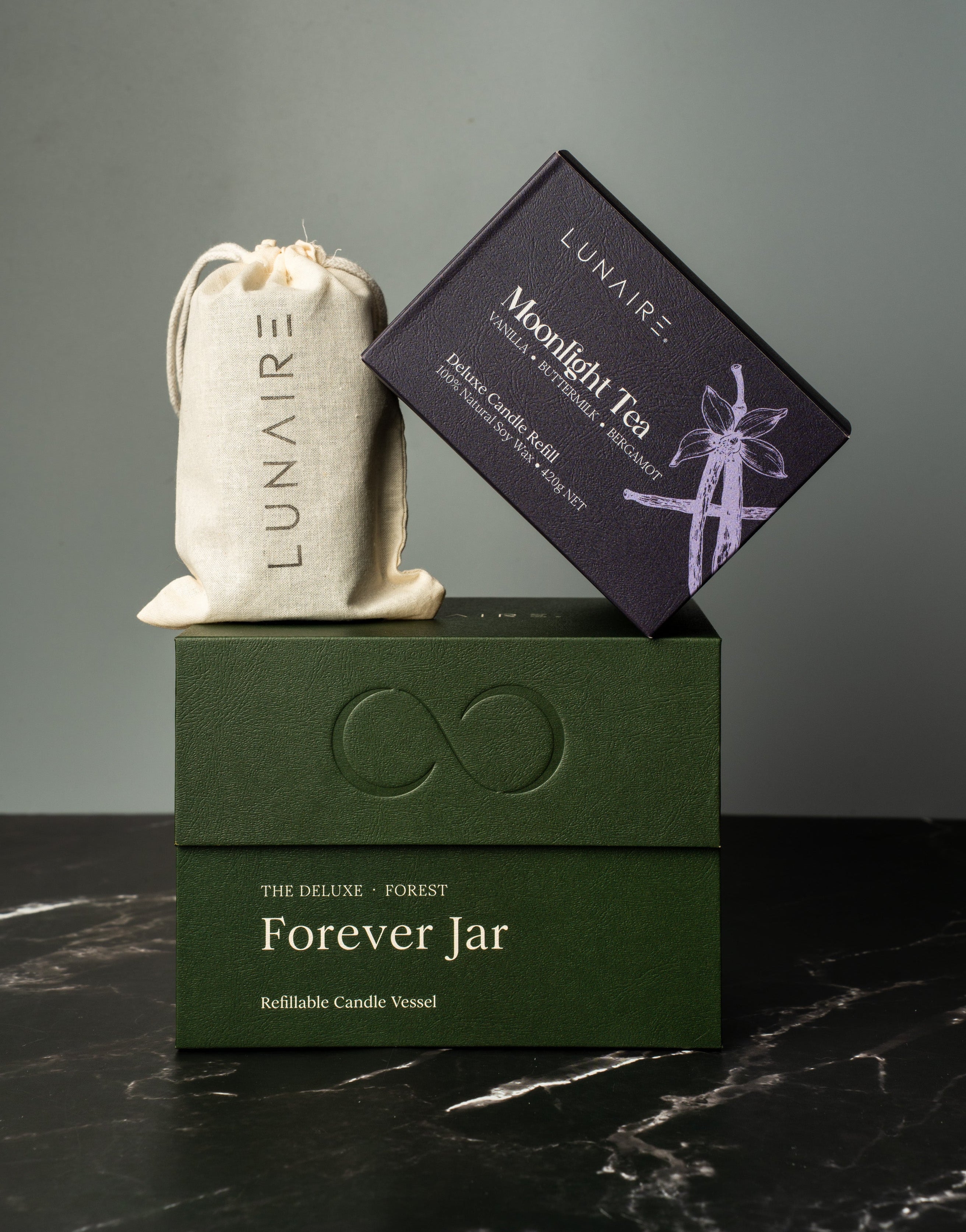 Lunaire product set including a green box, white bag, and black card on a dark surface with gray background