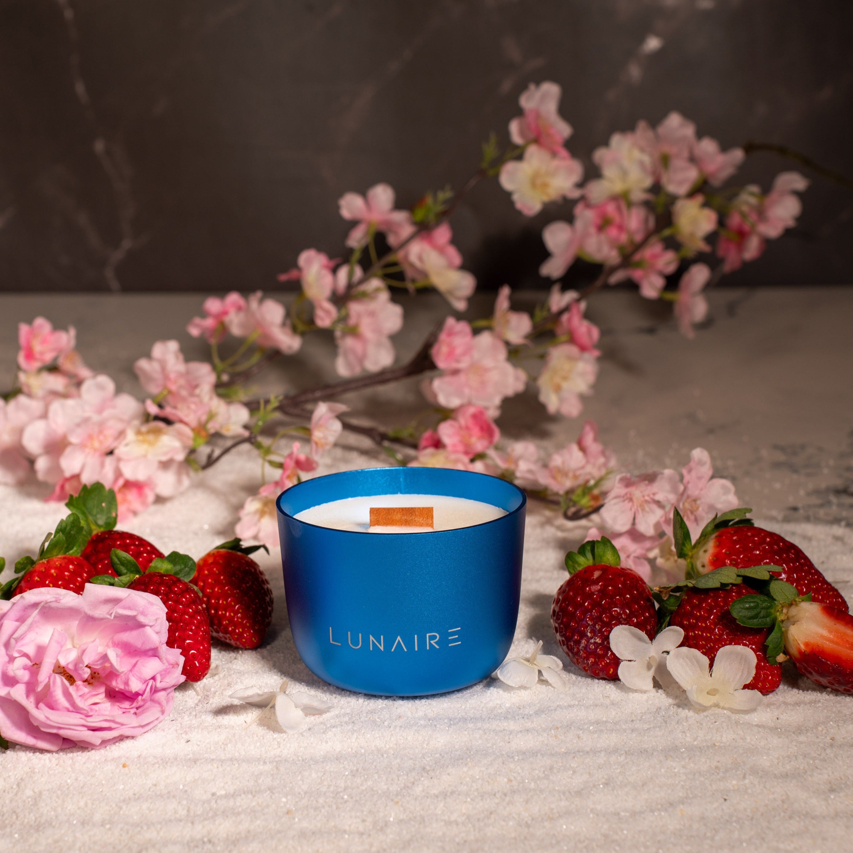 Blue Venus Lunaire Candle with Rose, cherryblossom, strawberry and jasmine in the background