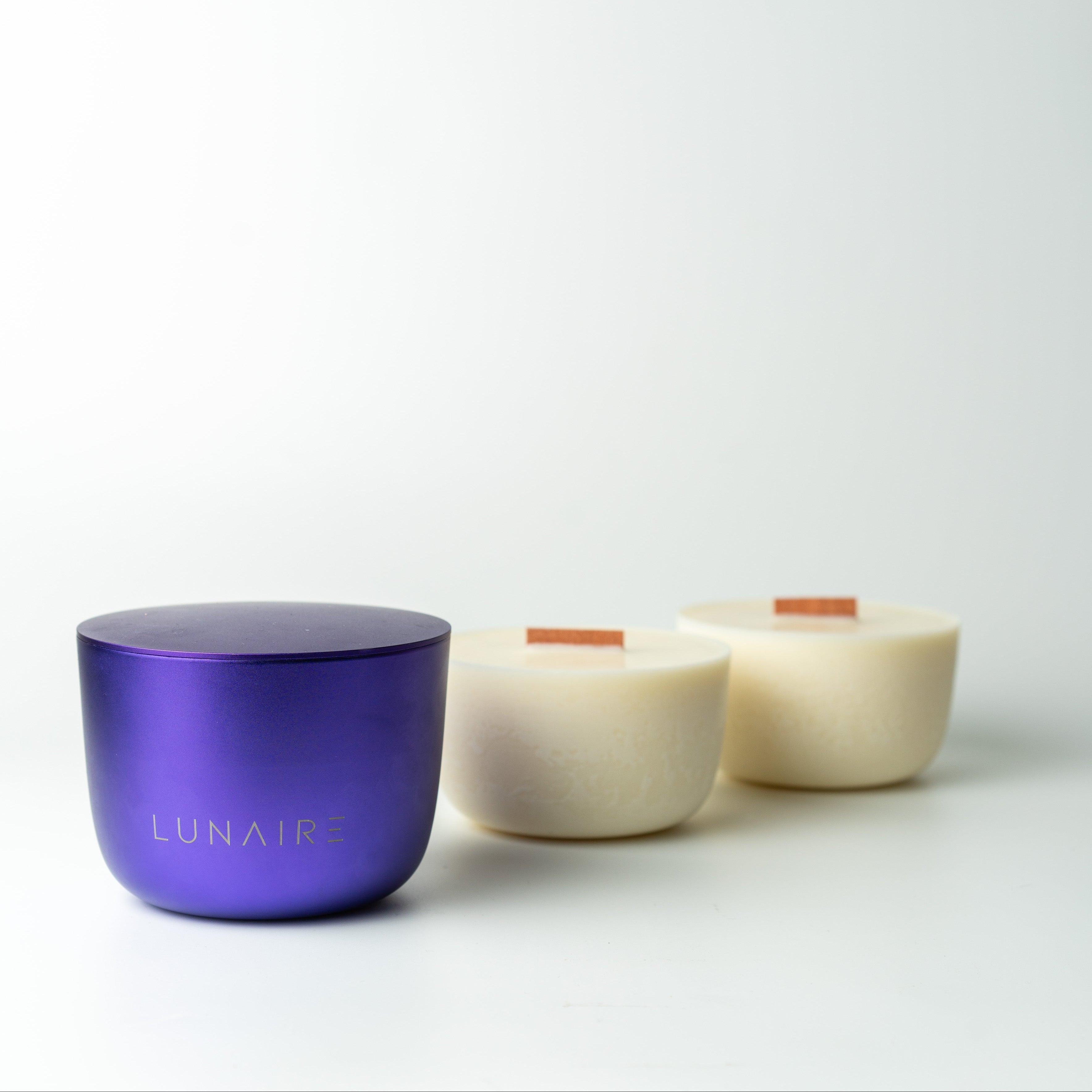 Lunaire soy vegan candle refills with wood wicks and purple aluminium candle vessel