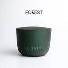Dark green aluminium candle  with 'LUNAIRE' branding on a white background