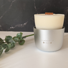 Lunaire forever candle  in a silver holder with 'In Memory of Ted' text on a marble surface.