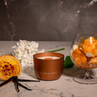 Bronze Jupiter Lunaire Candle with Creme Brulee, vanilla bean and caramel icecream in the background