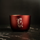 Burgundy luxury candle with a white horse engraving on a dark background. Lunar new year edition candle. 