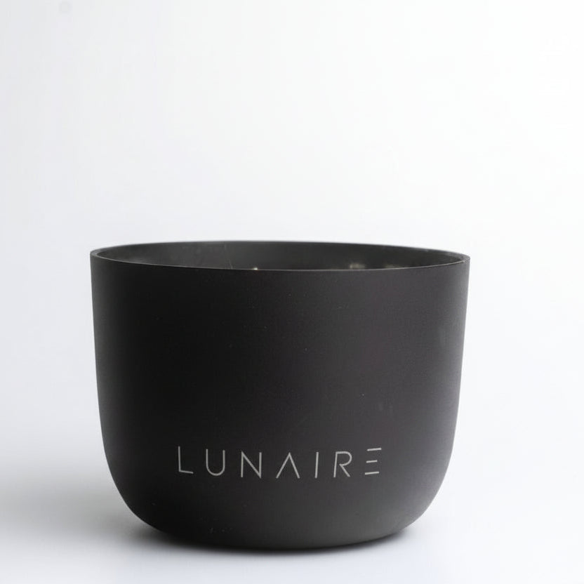 Black aluminium refillable candle with 'Lunaire' branding on a white background