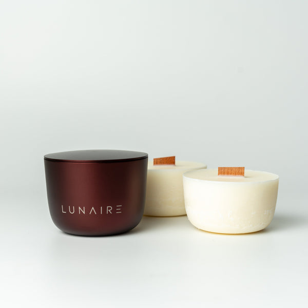 two soy candles and burgundy aluminium candle jar with 'LUNAIRE' branding on a white background