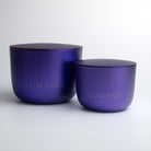 Two purple aluminium candle jars with 'LUNAIRE' branding on a white background