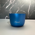 Blue cup with 'Hannah' branding on a marble surface
