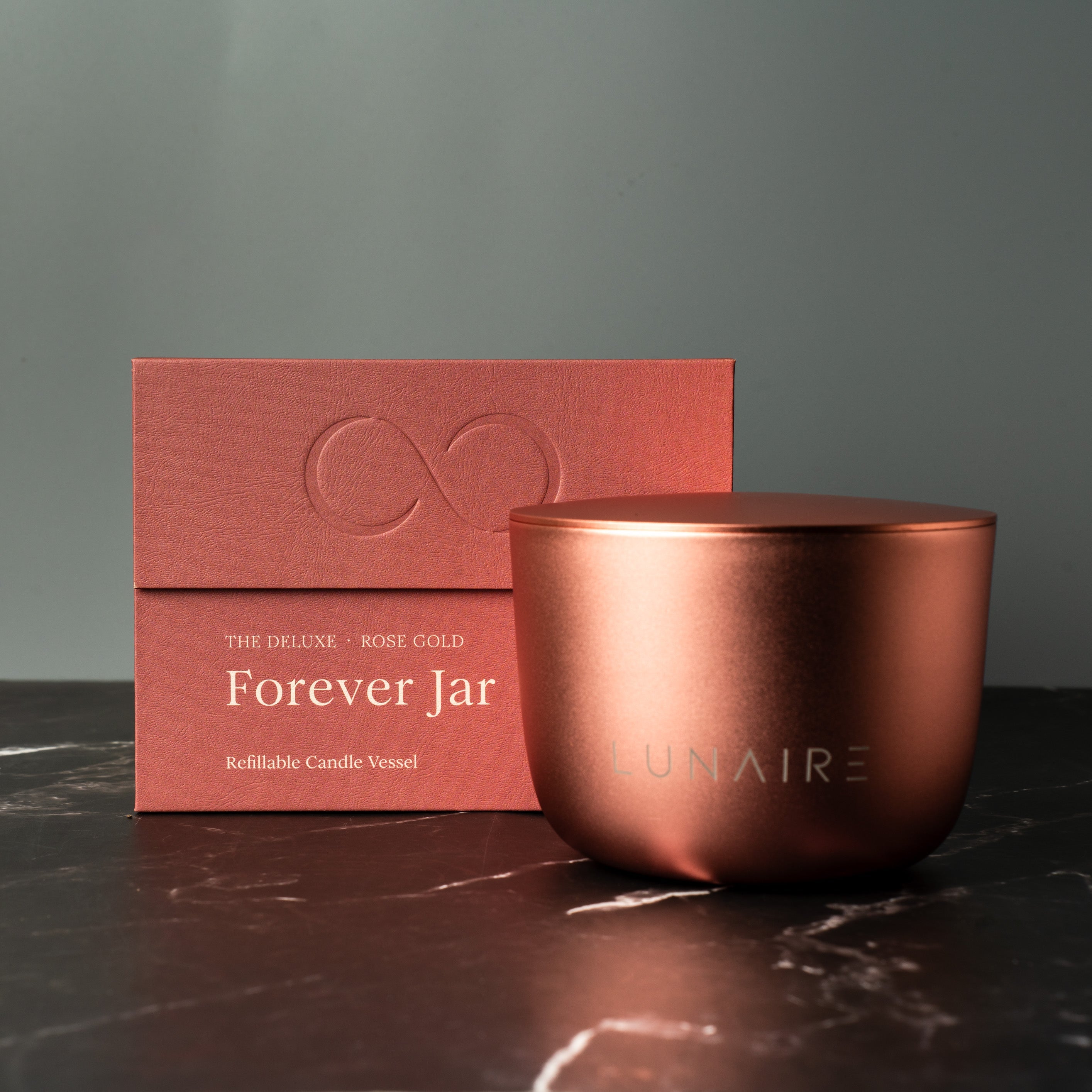 Rose Gold candle jar with 'Forever Jar' packaging on a dark surface. Luxury Premium Candle Gift 
