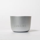 A silver aluminum candle holder with the brand name 'LUNAIRE' engraved on the front.