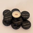 Candle with black lids labeled 'Happy Diwali' and 'Lunaire' on a beige background